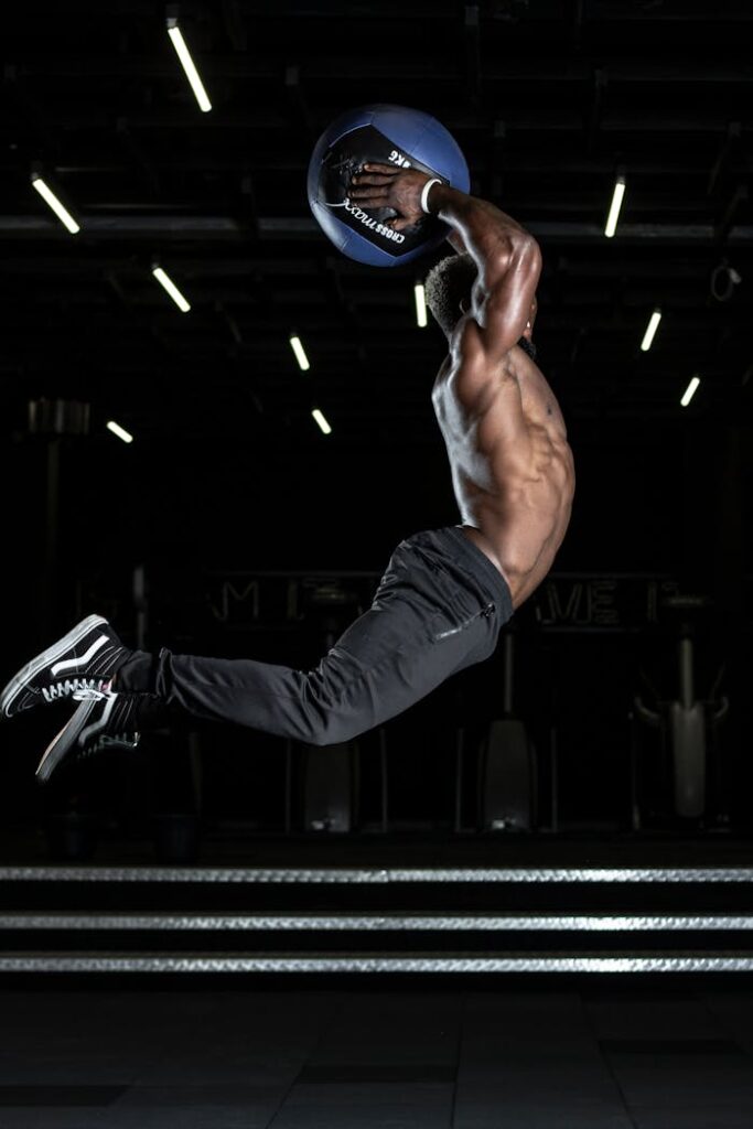pexels-photo-2827400 Man Jumping in Mid Air Holding Blue Ball Above His Head